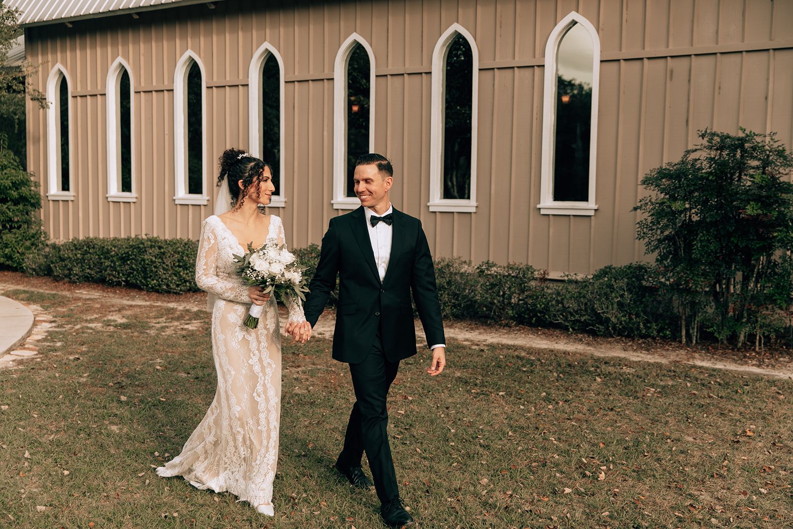 bride and groom walk outside chapel valley farm in eustis florida