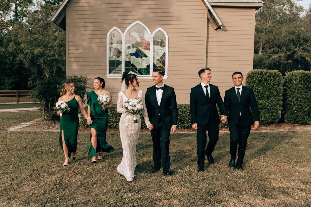 bride and grooms wedding party outside of the chapel in eustis