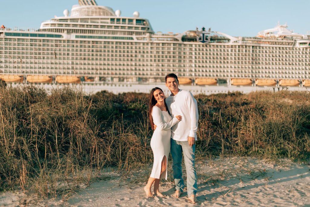 bride and groom take a photo with a passing cruise ship as a core memory for their engagement shoot
